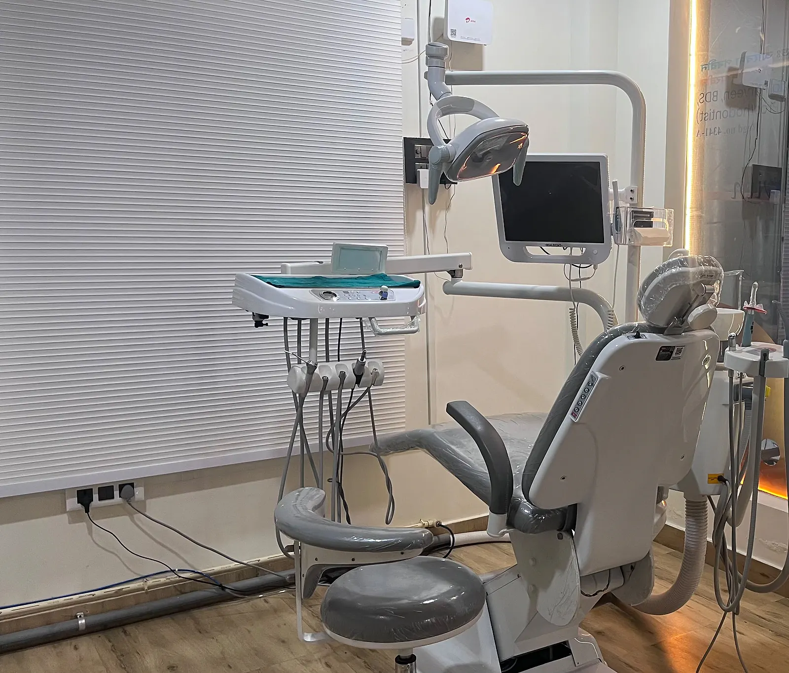 A treatment room at Dental Artistry: the dental chair, instrument tray and monitor beside the front window